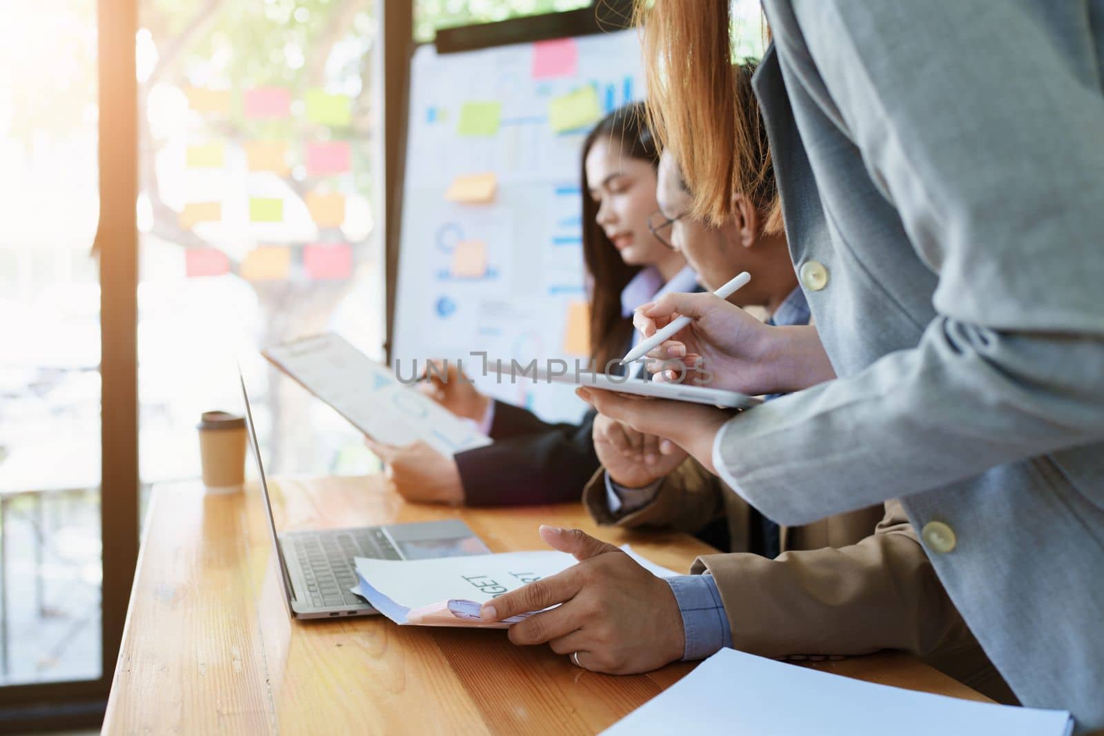 Asian entrepreneurs and business people meeting in a conference room in business planning, financial budget and investment risk assessment to analyze customer groups to increase company growth by Manastrong