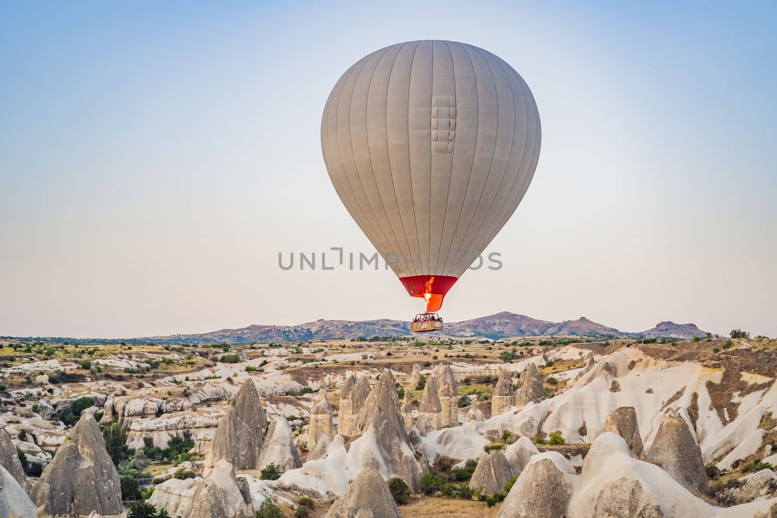 Colorful hot air balloon flying over Cappadocia, Turkey by galitskaya