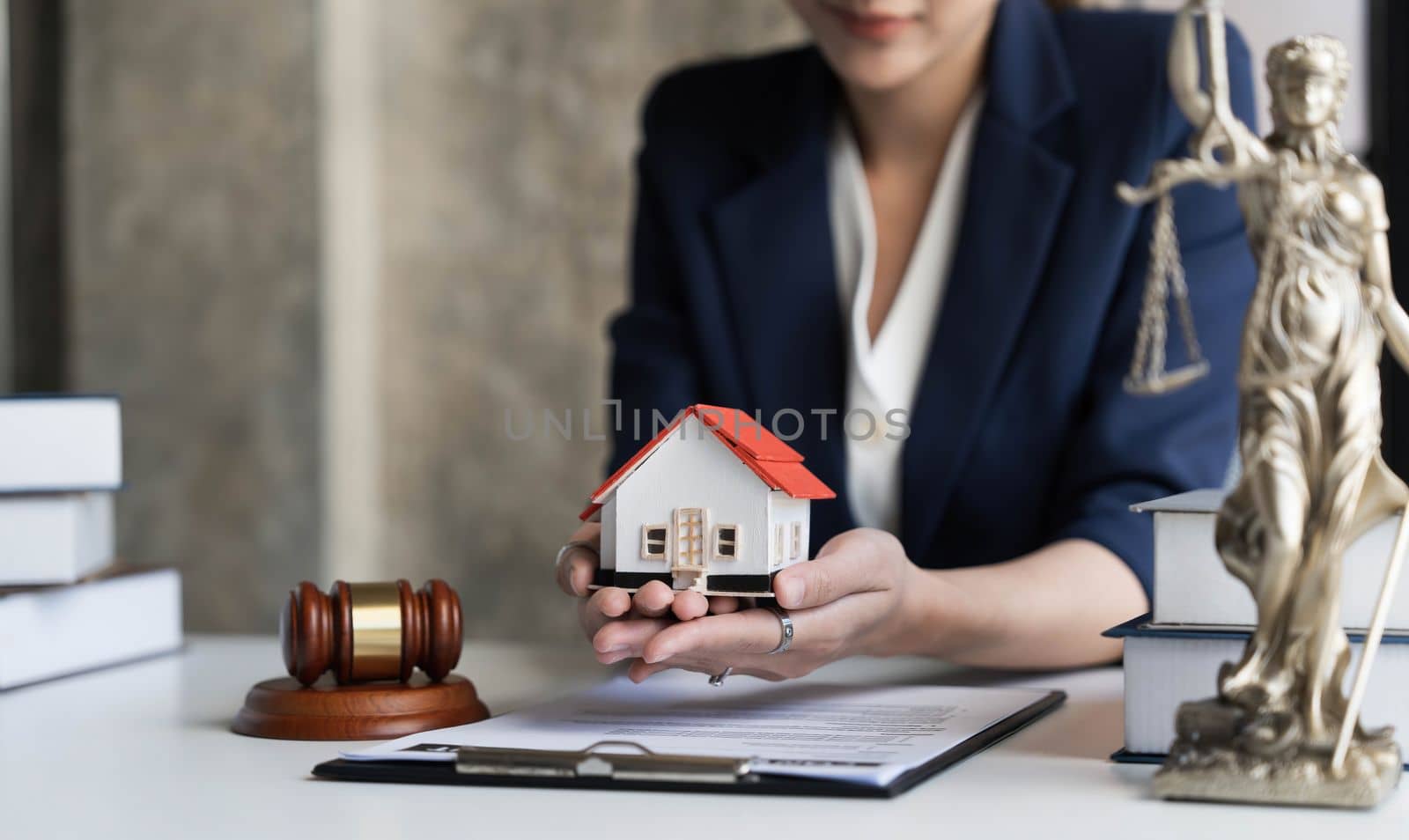 Real estate concept, businesswoman holding a house icon. House on Hand.Property insurance and security concept. Protecting gesture of female and symbol of house