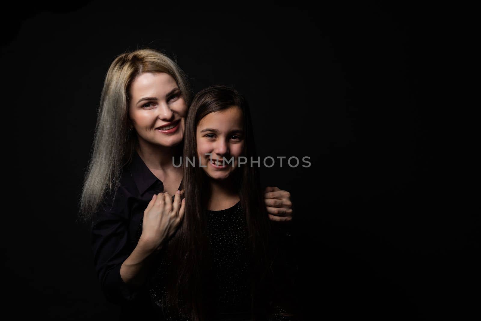 Little girl hugs her mother