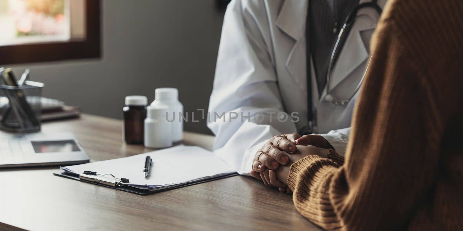 Close up doctor hold hand of patient give comfort, express health care sympathy, medical help trust support encourage reassure infertile patient at medical visit, closeup view..