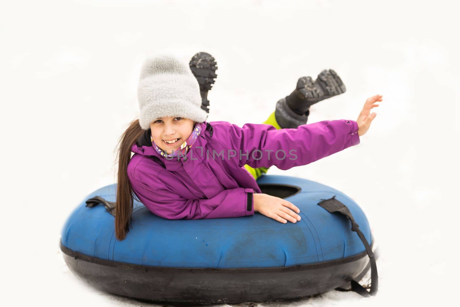 Children ride on tubing. Winter entertainment. Tubing. People roll on the slides