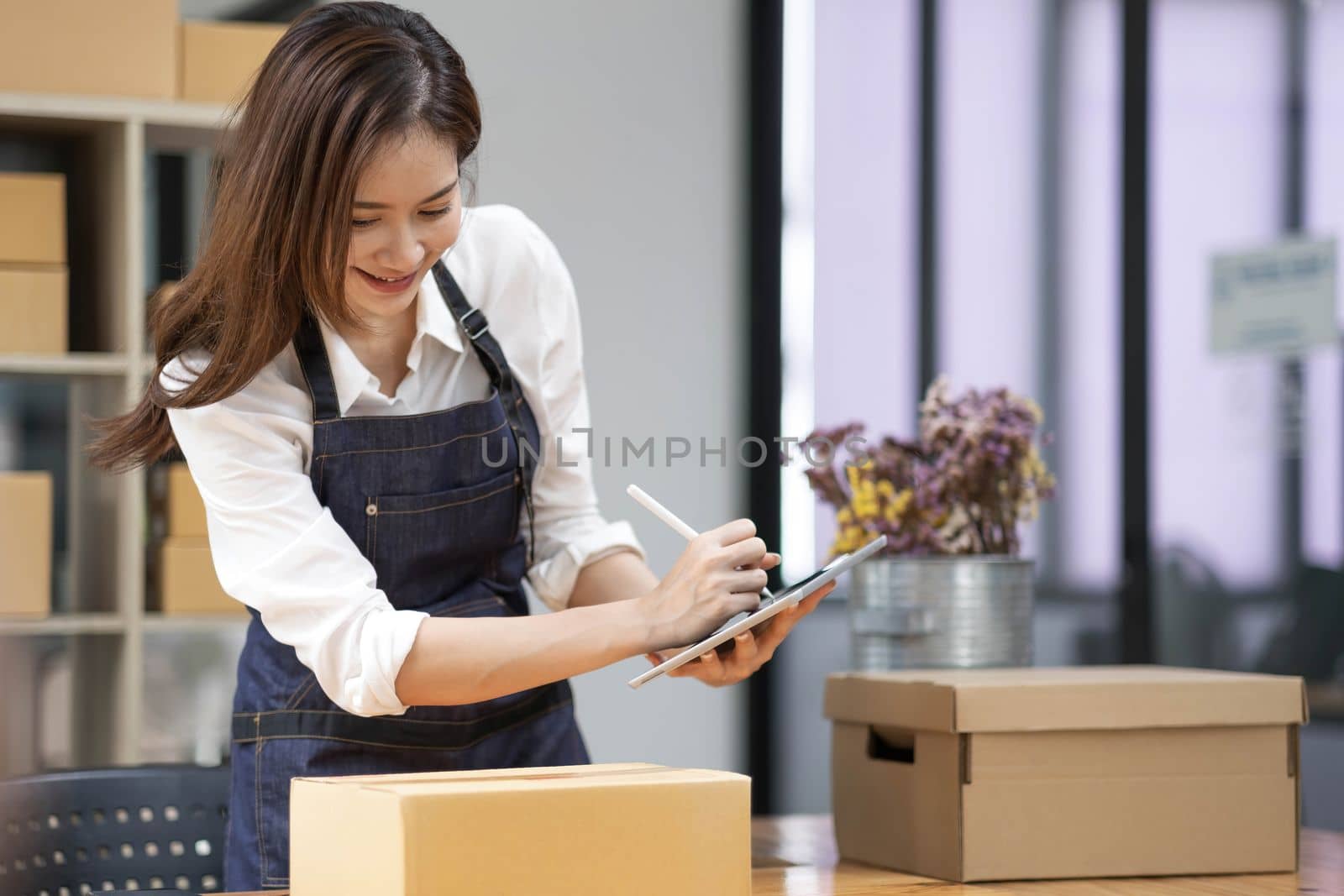 Successful entrepreneur business woman with online sales and Parcel shipping in her home office, prepare parcel box of product for deliver to customer...