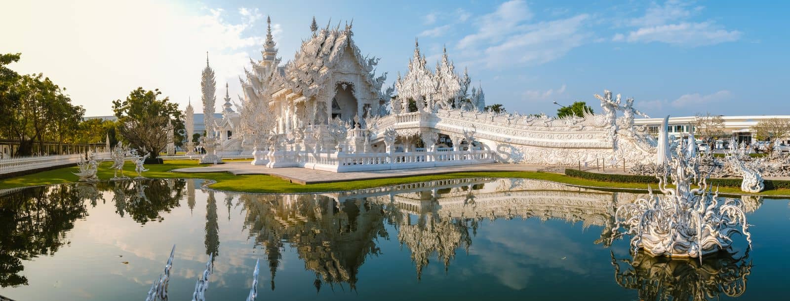 White Temple Chiang Rai Thailand with reflection in the water, Wat Rong Khun or White Temple, Chiang Rai, Northern Thailand.