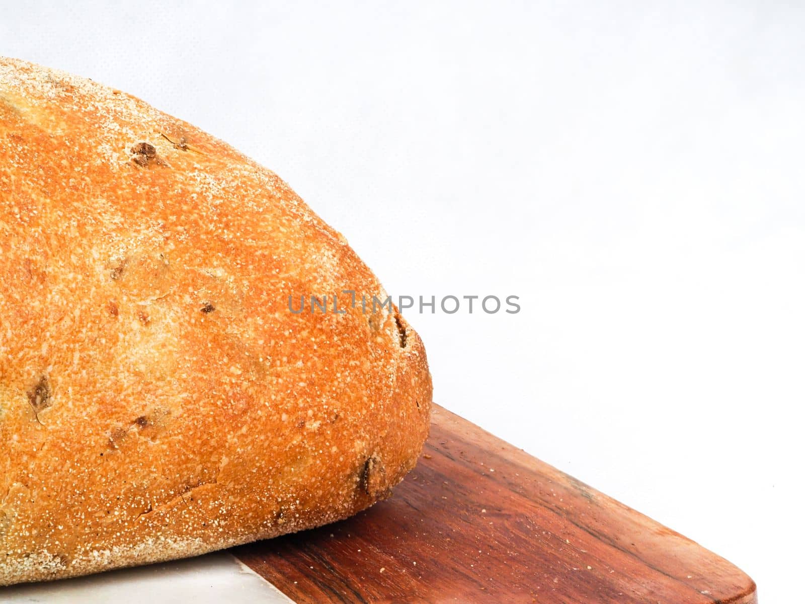 Olive loaf, olive bread, a bread laced with whole olives on white background