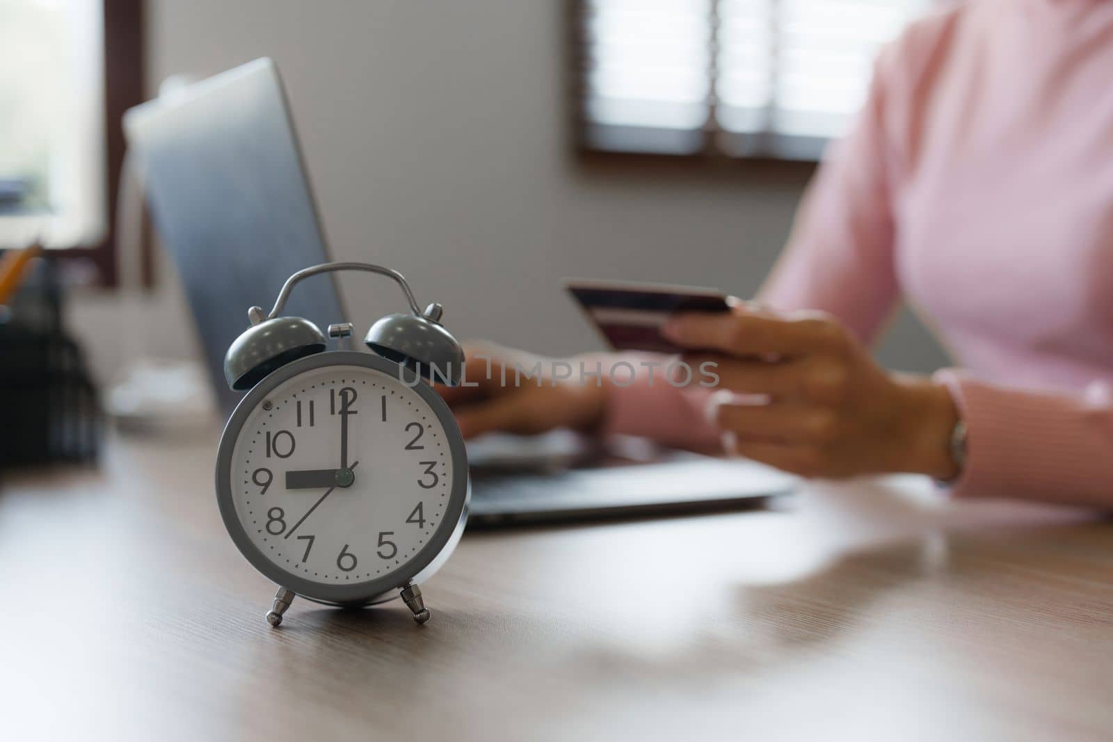 Young person using credit card and laptop computer. Online shopping, e-commerce concept by itchaznong