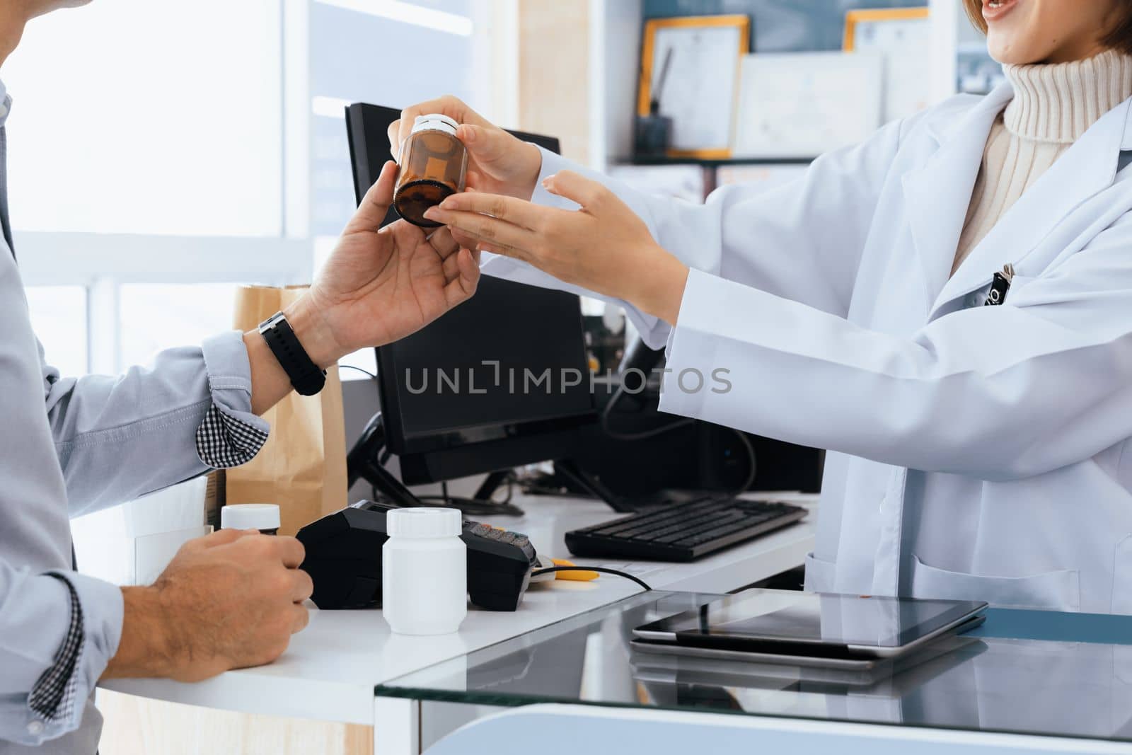 Closeup professional pharmacist advise or explain property of qualified medical product to customer in pharmacy, druggist answer to client healthcare inquiry, medical service and consultation concept.