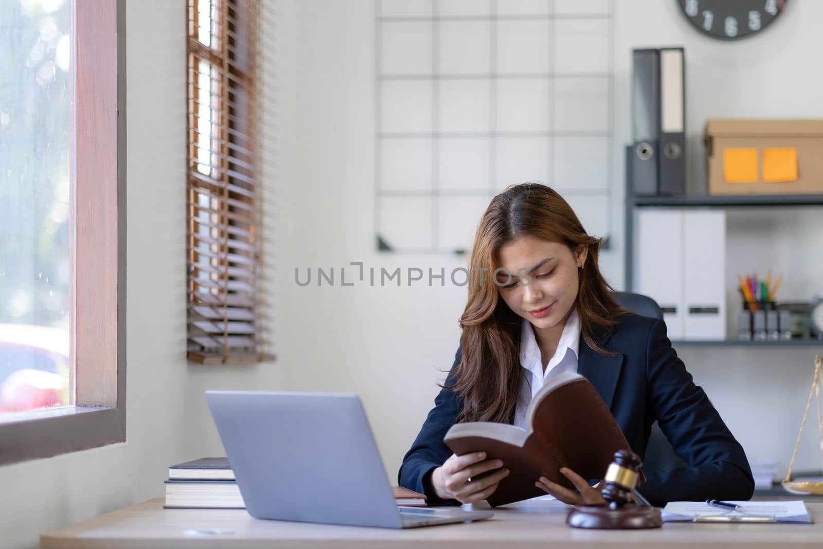 Beautiful asian woman lawyer working and gavel, tablet, laptop in front, Advice justice and law concept