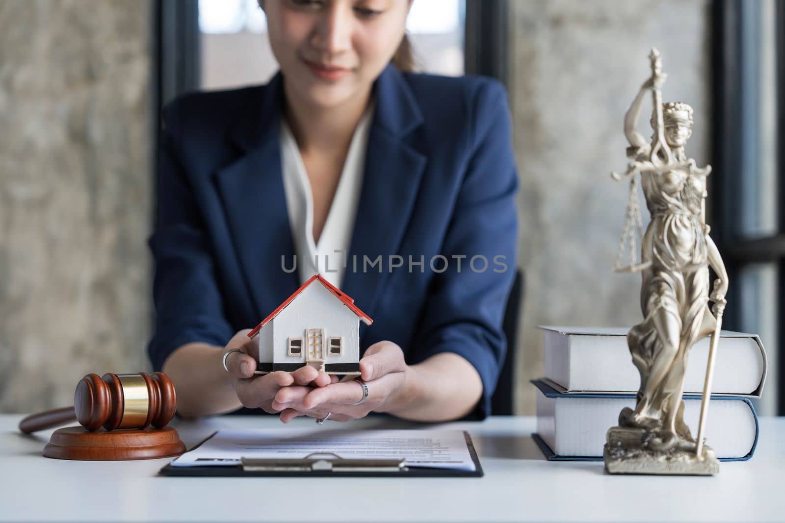 Real estate concept, businesswoman holding a house icon. House on Hand.Property insurance and security concept. Protecting gesture of female and symbol of house