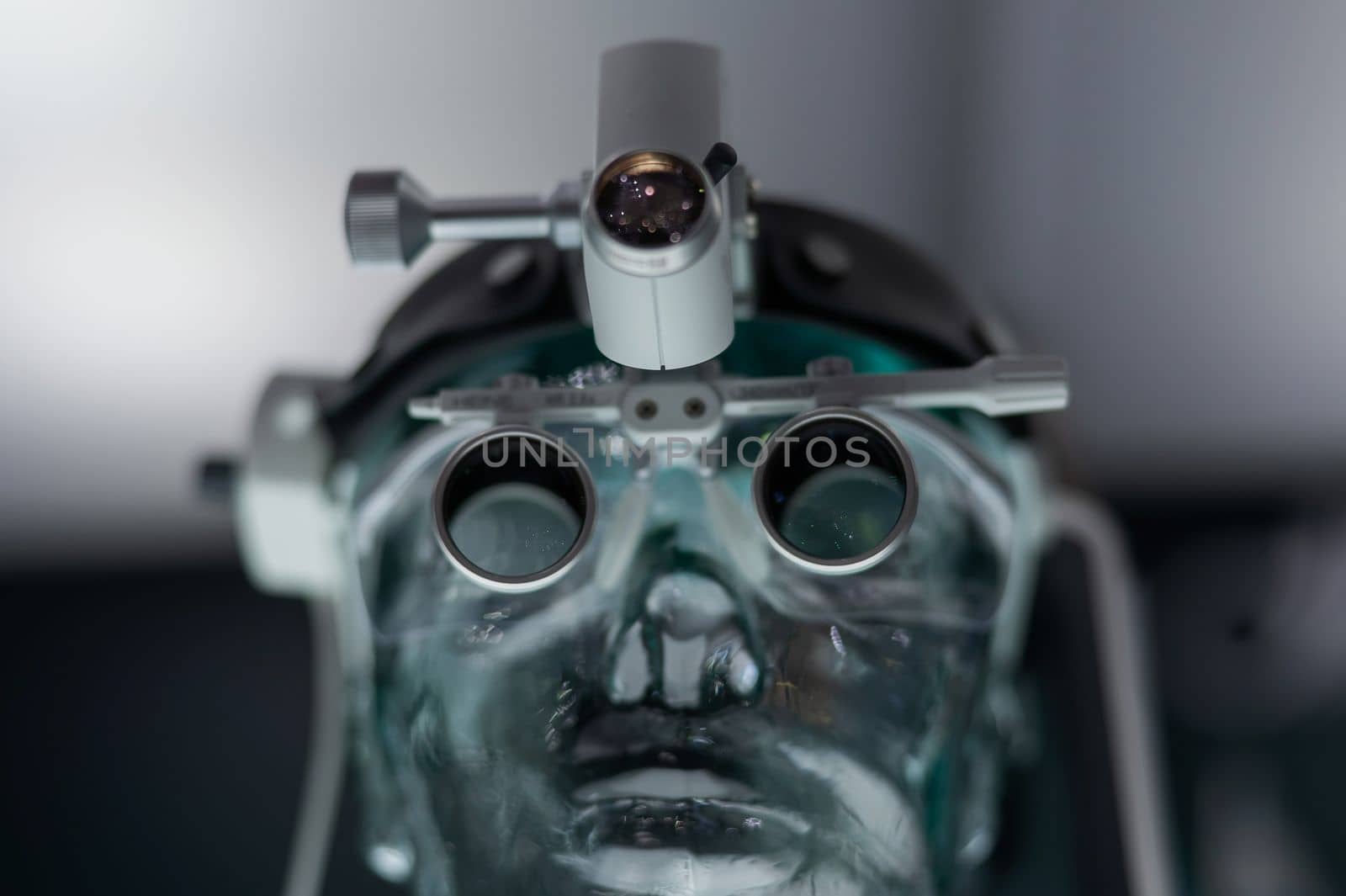 Dentist's microscope on a transparent mannequin at a medical exhibition. by mrwed54