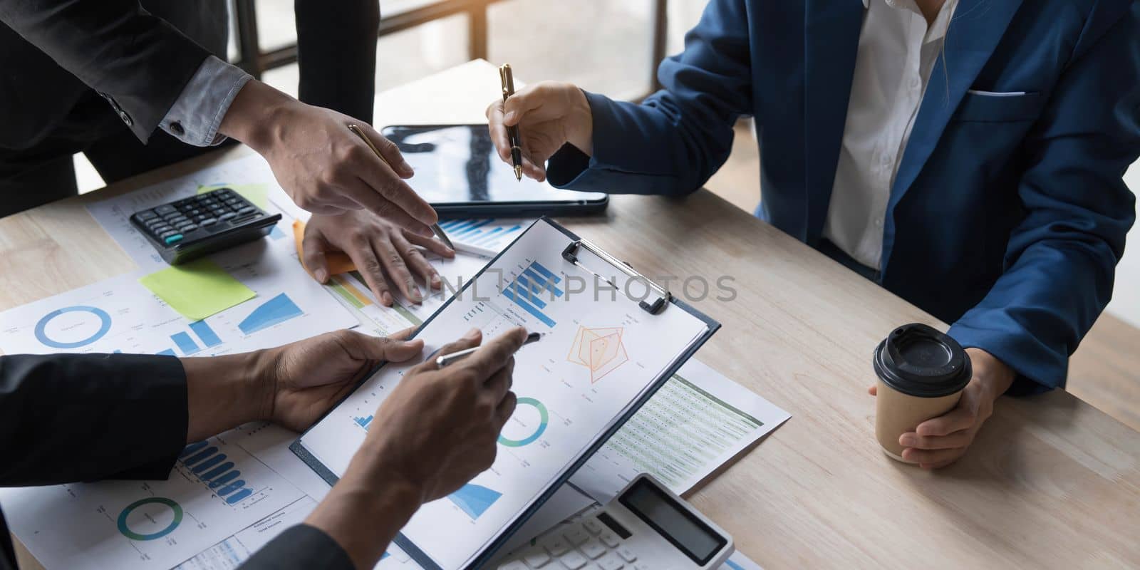 Business People Meeting using laptop computer,calculator,notebook,stock market chart paper for analysis Plans to improve quality next month. Conference Discussion Corporate Concept...