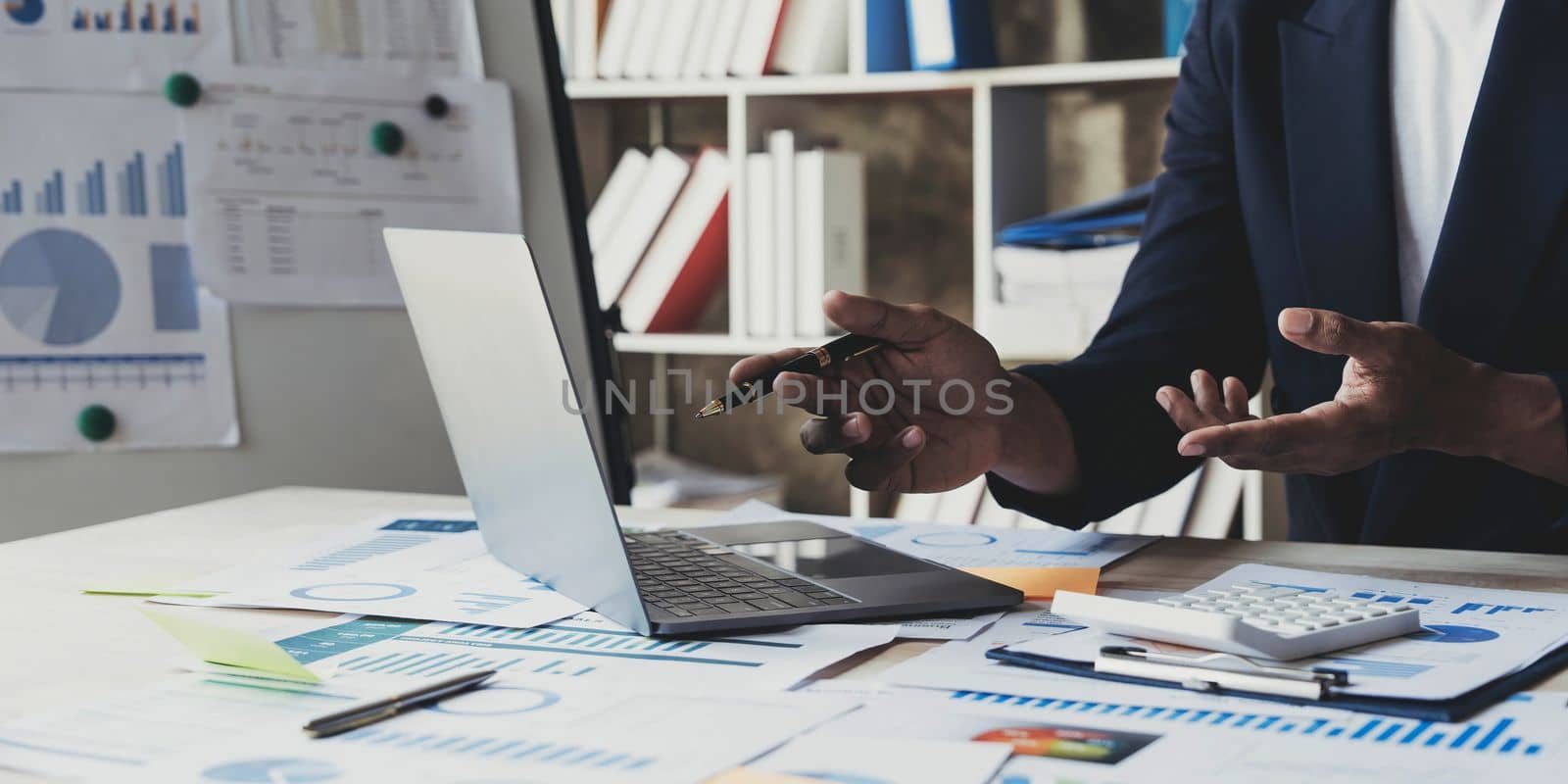 Close up man working about financial with calculator at his office to calculate expenses, Accounting concept by wichayada