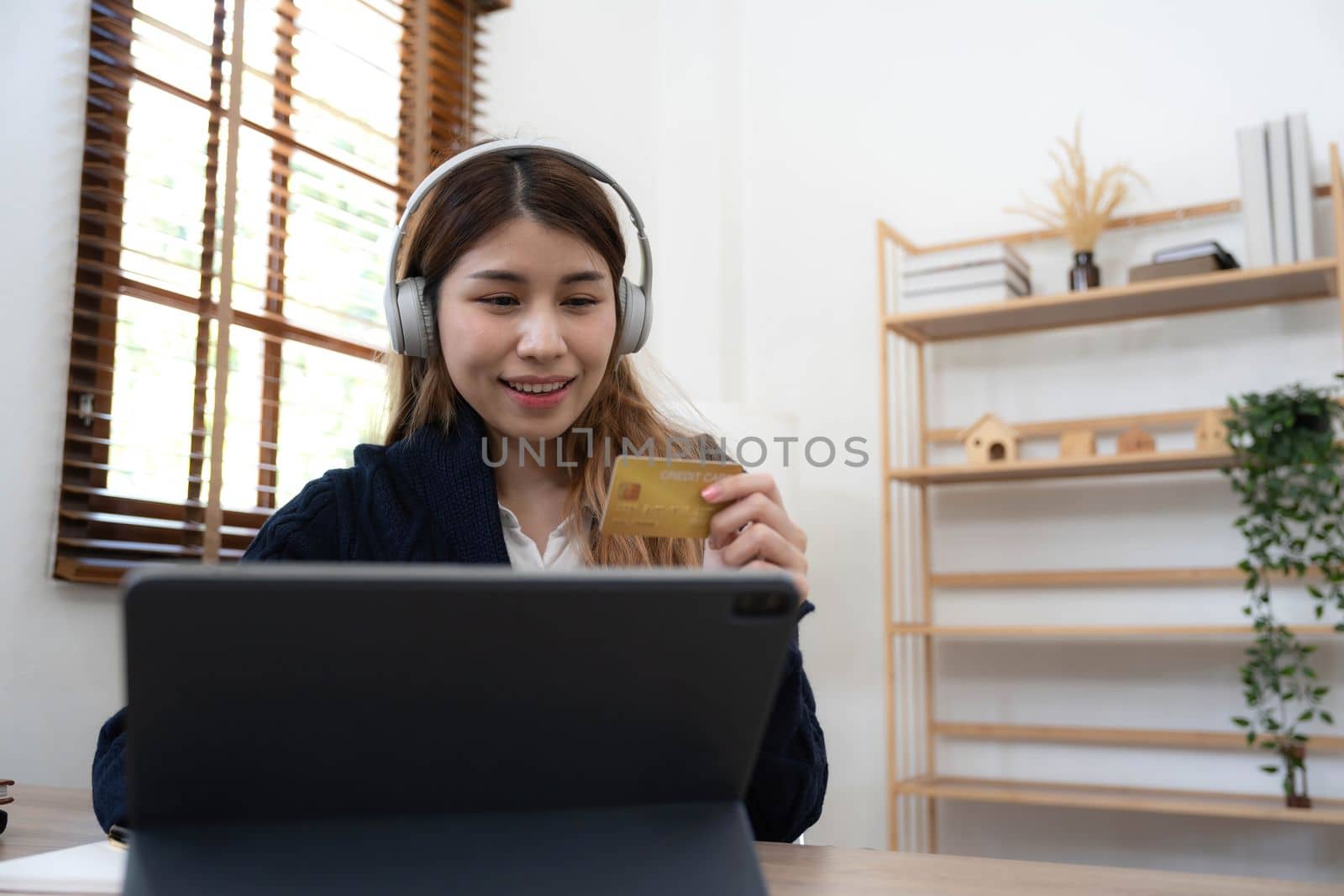Young Asian business woman using smartphone and credit card for online shopping. Online Payment