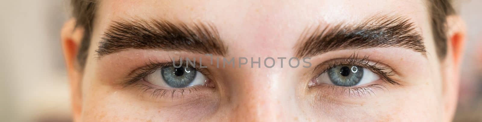 Close-up portrait of a woman after the procedure of correction and lamination of eyebrows. by mrwed54