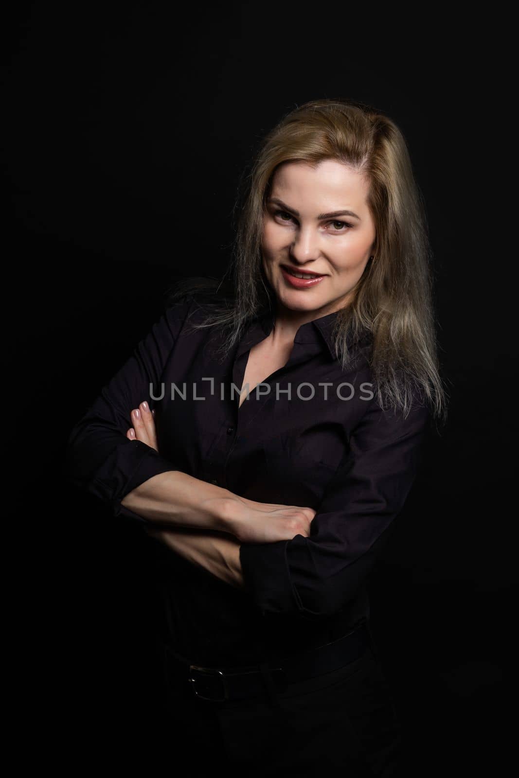 Elegant blonde beautiful middle aged lady posing, smiling to the camera. Attractive businesswoman