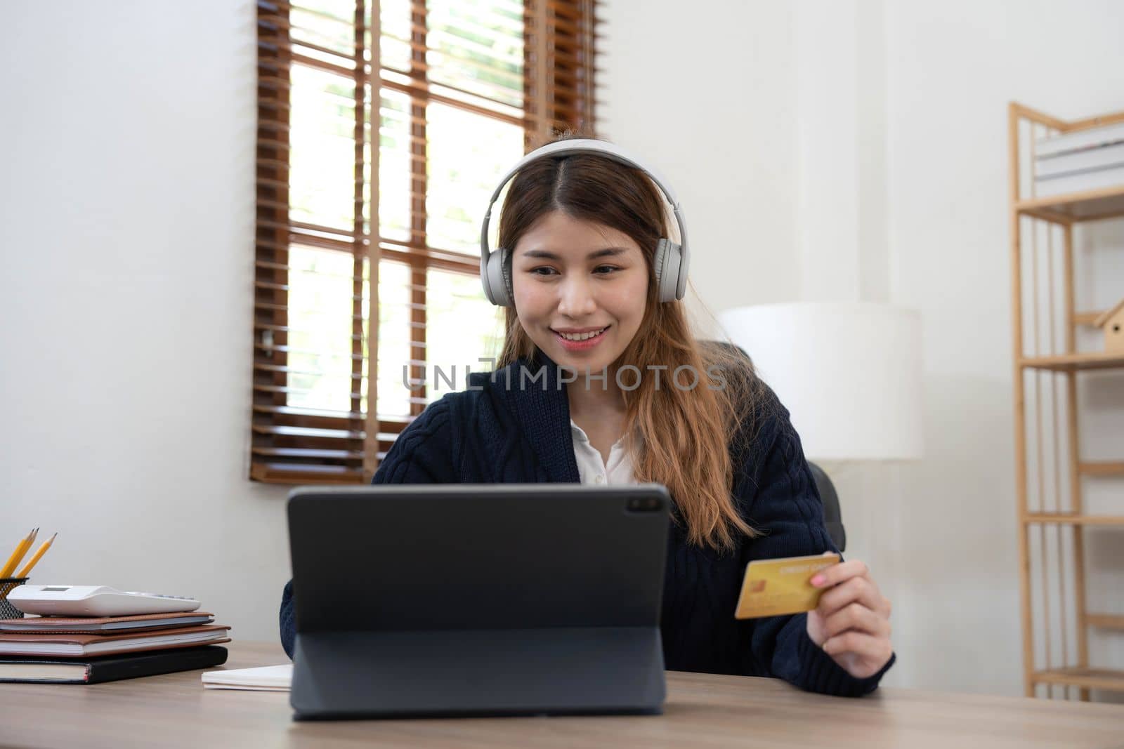 Young Asian business woman using smartphone and credit card for online shopping. Online Payment