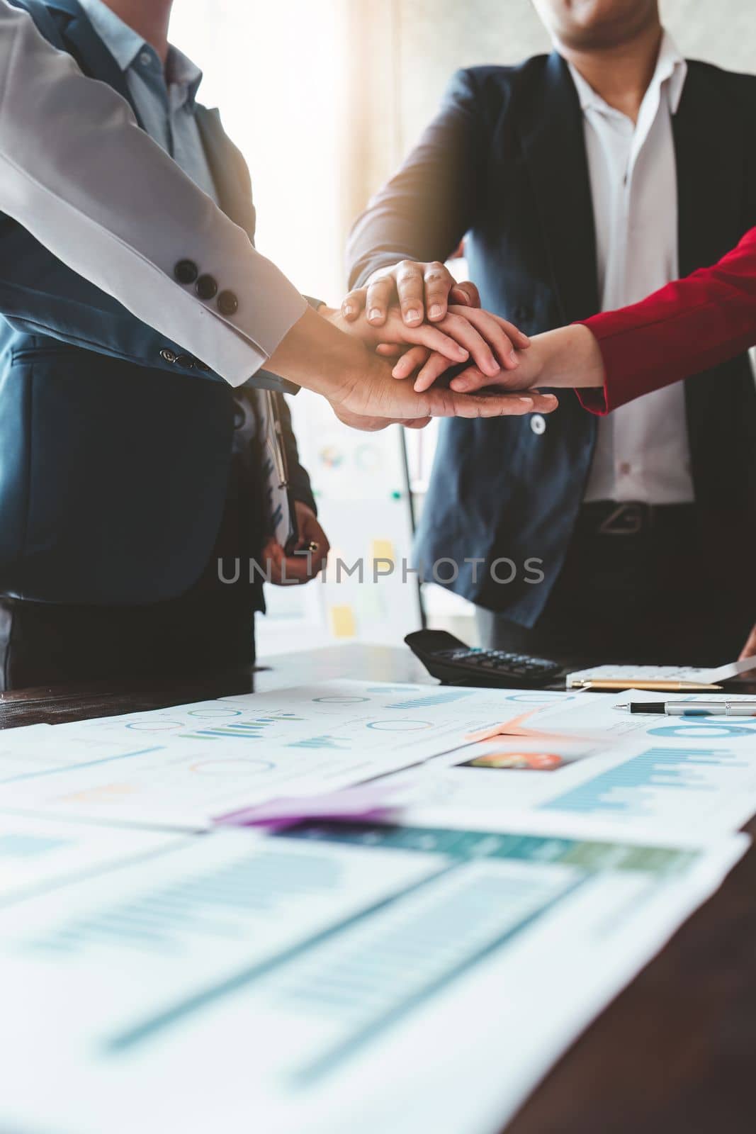 Close up Asian Business people stack of hands working together. Teamwork, Unity, business team concept by itchaznong