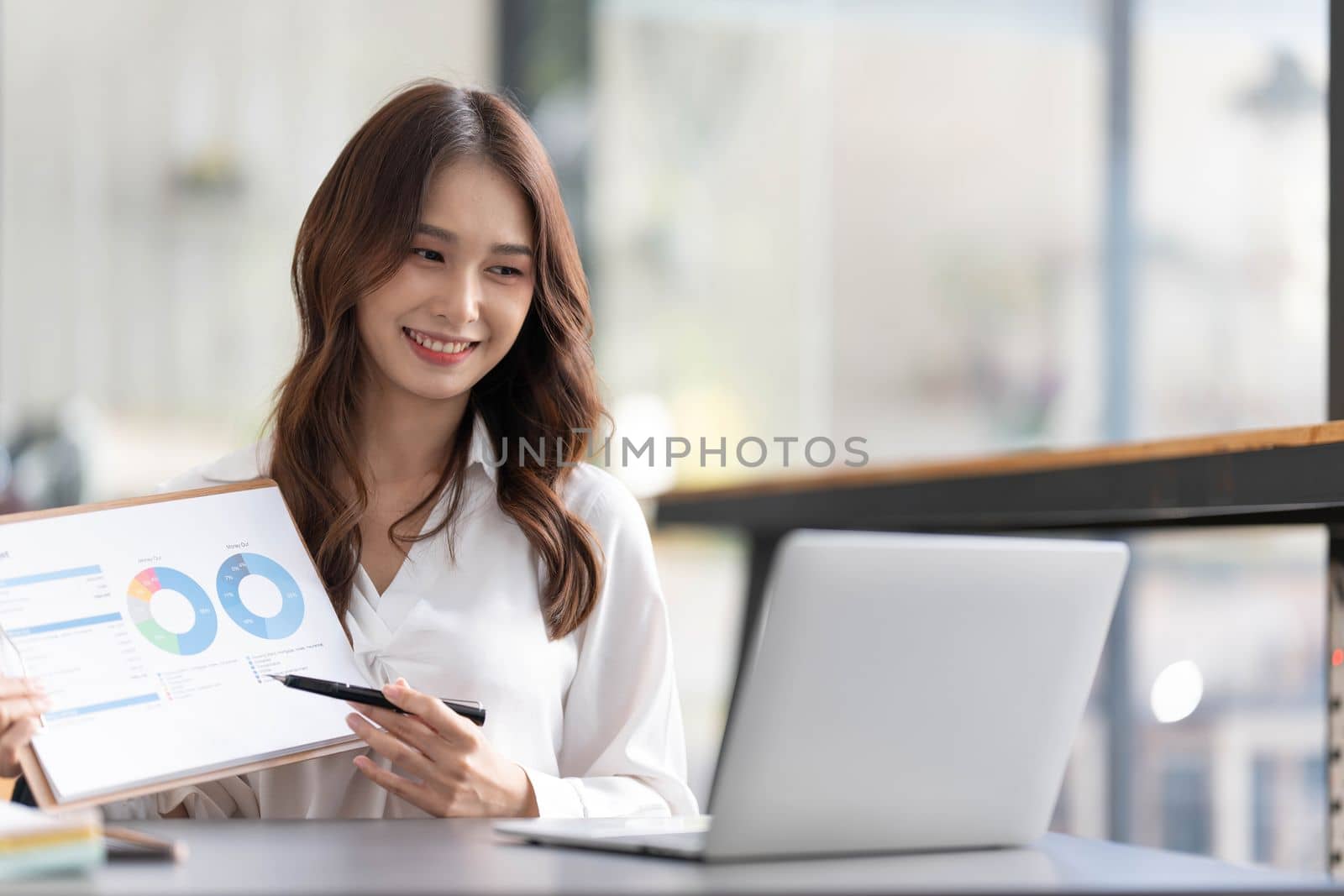Businesswoman presenting charts and graphs on video call online. Asian Business woman having conference call with client on laptop. Closeup business woman working laptop computer indoor...
