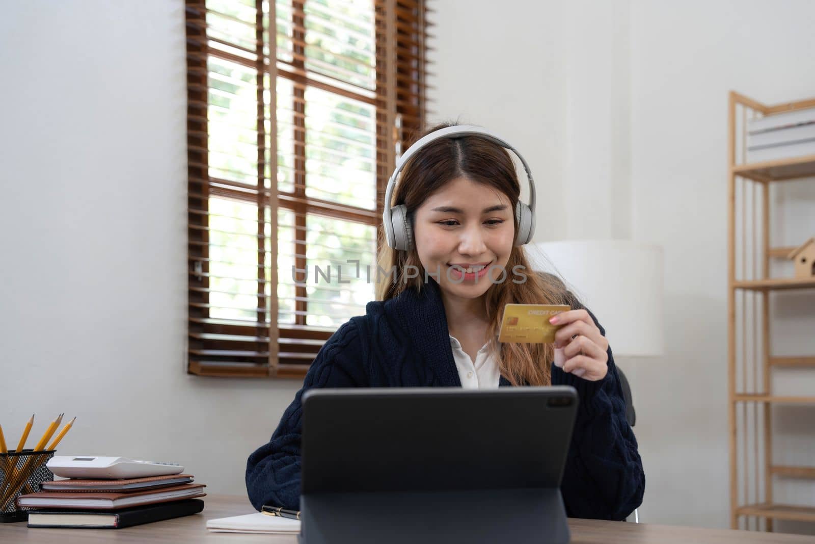 Young Asian business woman using smartphone and credit card for online shopping. Online Payment