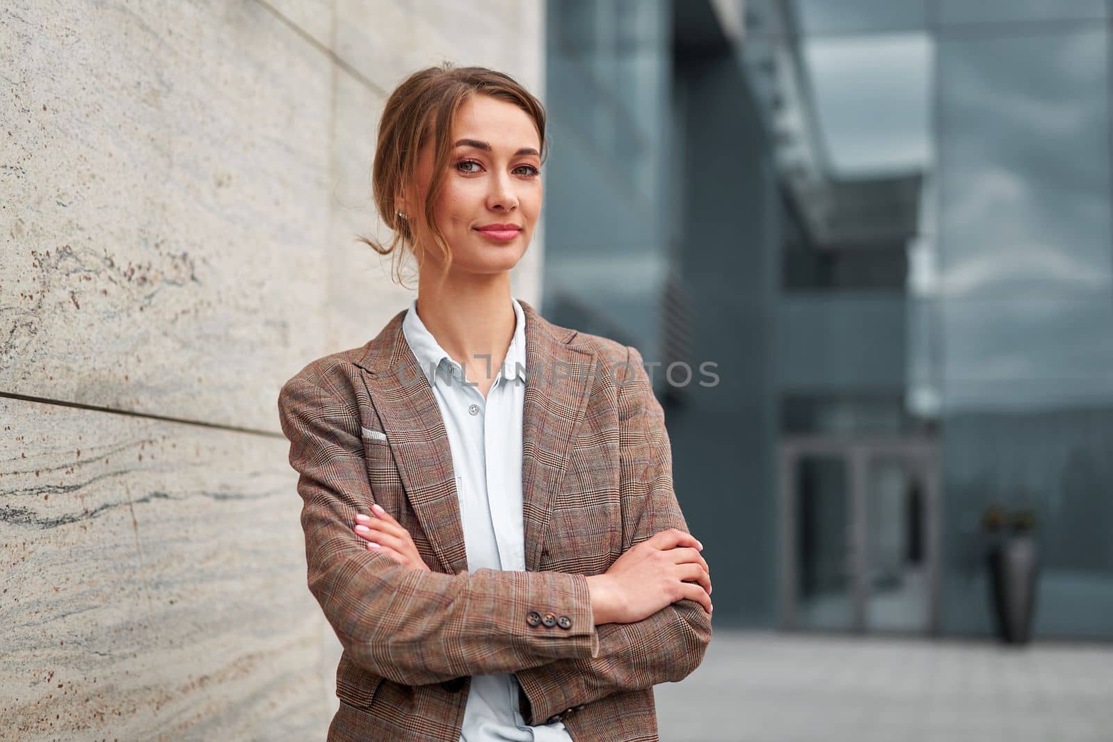 Businesswoman successful woman business person standing arms crossed outdoor corporate building exterior Smile happy caucasian confidence professional business woman middle age female entrepreneur