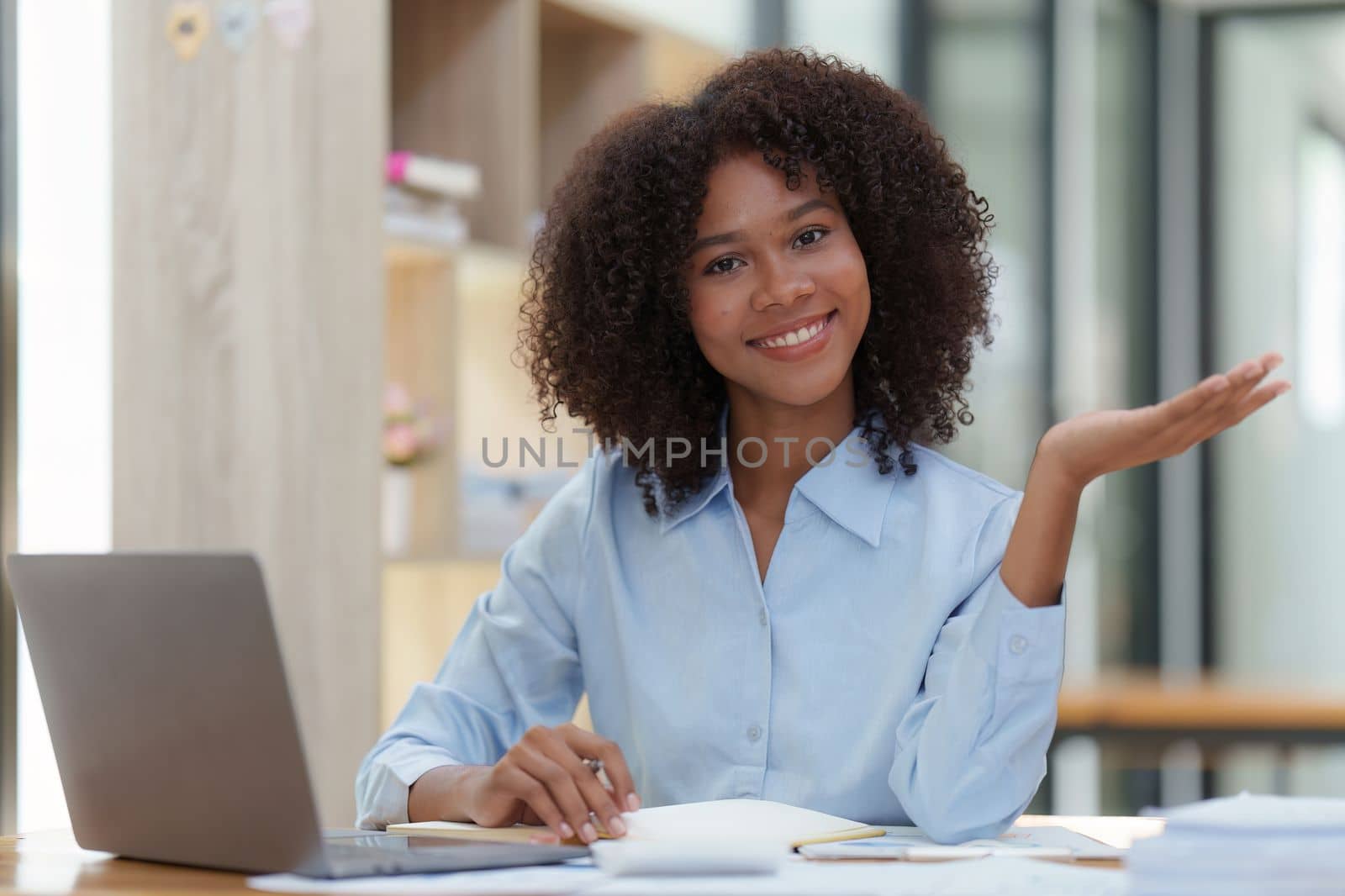 Young African American businesswoman working by laptop at office, Focus at screen laptop, reading interesting article online and finance.