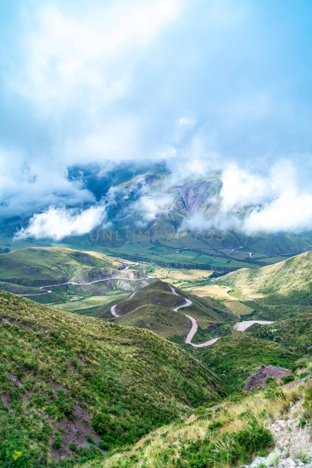 winding mountain roads in the Andes Mountains with a sky overcast with clouds.  by Edophoto