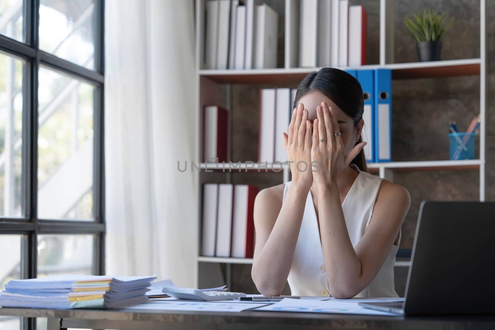 Young Business Asian women are stressed while working on laptop, Tired asian businesswoman with headache at office, feeling sick at work copy space in workplace an home office...
