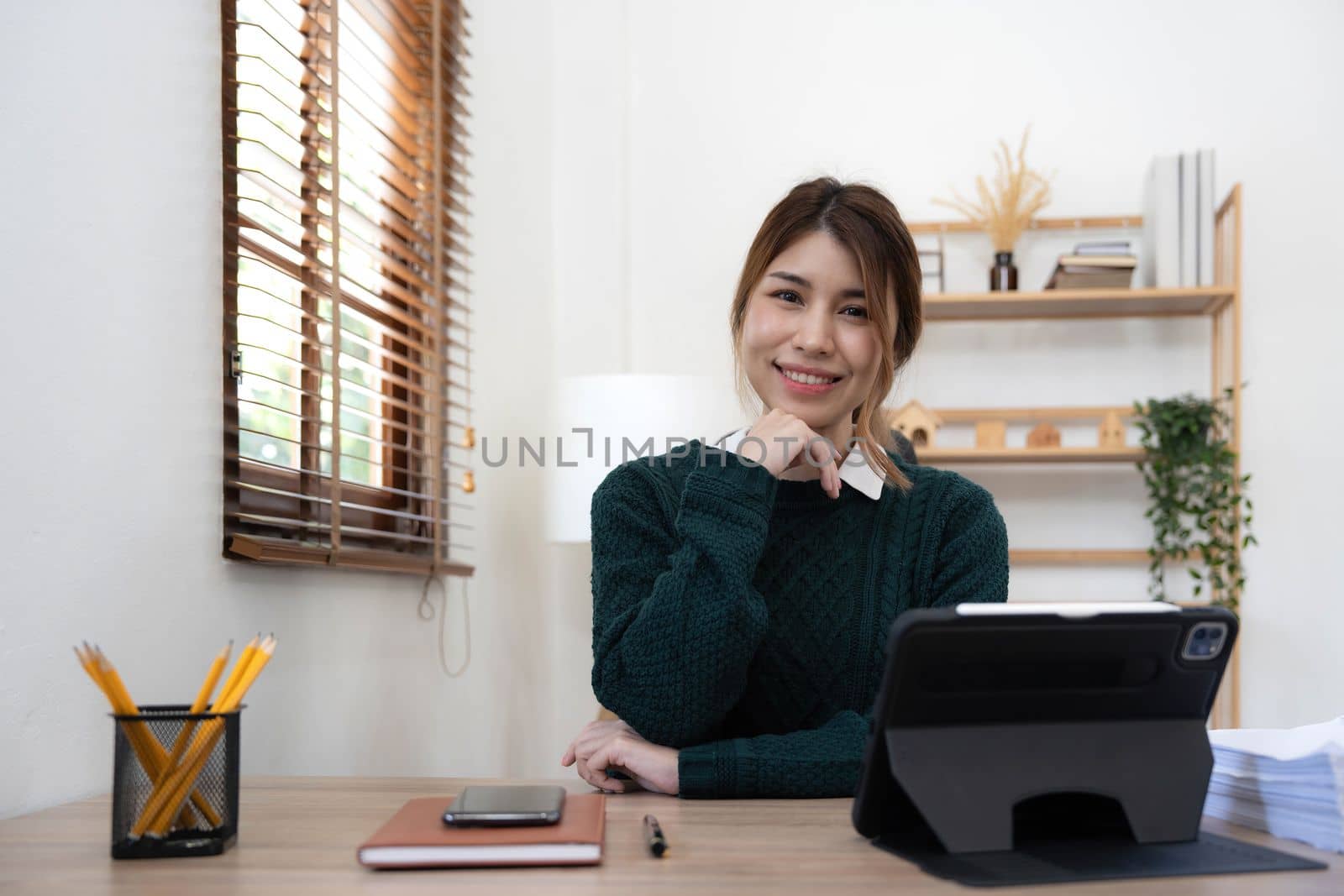 Portrait of smiling beautiful business asian young woman working in office use computer with copy space