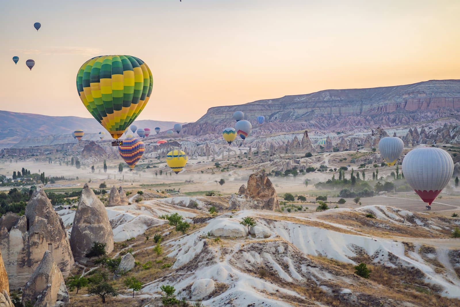 Colorful hot air balloon flying over Cappadocia, Turkey by galitskaya