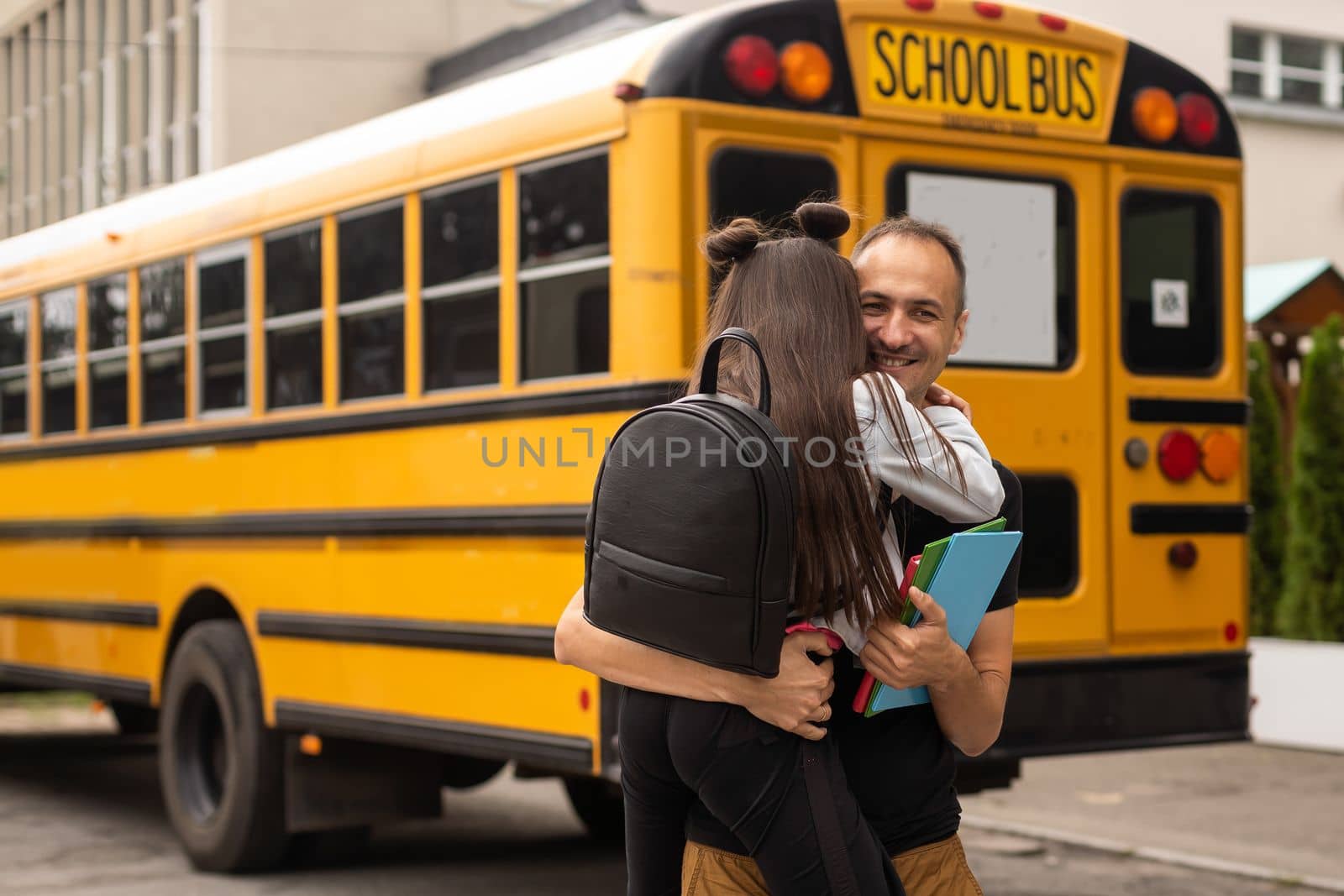 Parent taking child to school. Pupil of primary school go study with backpack outdoors. Father and son go hand in hand. Beginning of lessons. Back to school. First day of fall. Elementary student by Andelov13