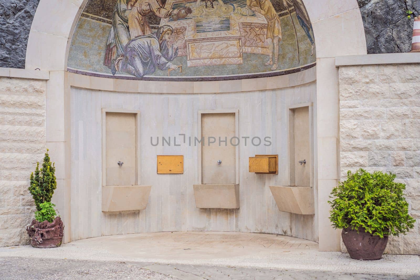 10.05.2022 Podgorica, Montenegro: Monastery of Ostrog, Serbian Orthodox Church situated against a vertical background, high up in the large rock of Ostroska Greda, Montenegro. Dedicated to Saint Basil of Ostrog by galitskaya