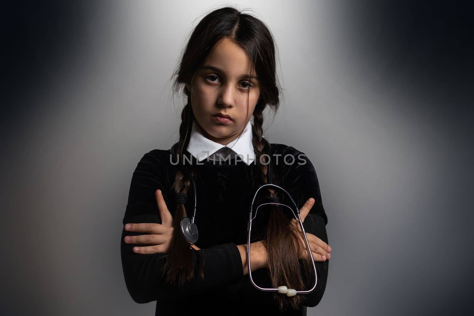 A girl with braids in a gothic style on a dark background with stethoscope. by Andelov13