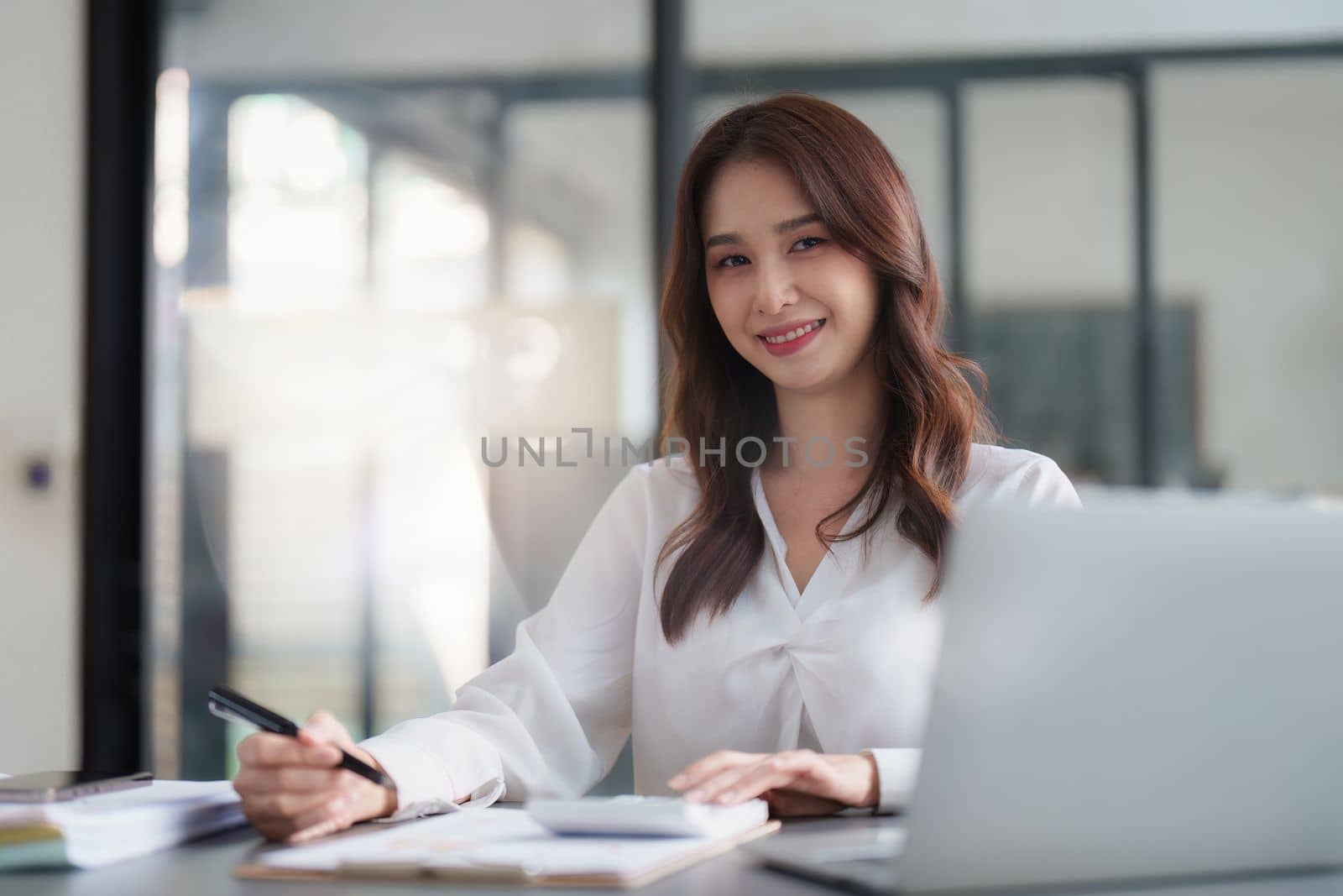 Asian Business woman working at home office and analyze financial report document. Accounting and Finance concept.