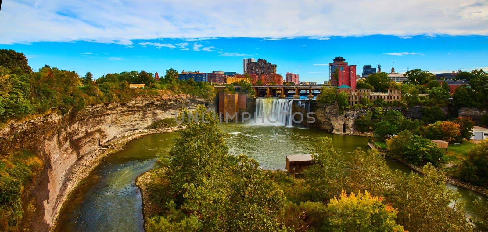 Beautiful Rochester city skyline from river canyon with huge waterfall over cliffs by njproductions