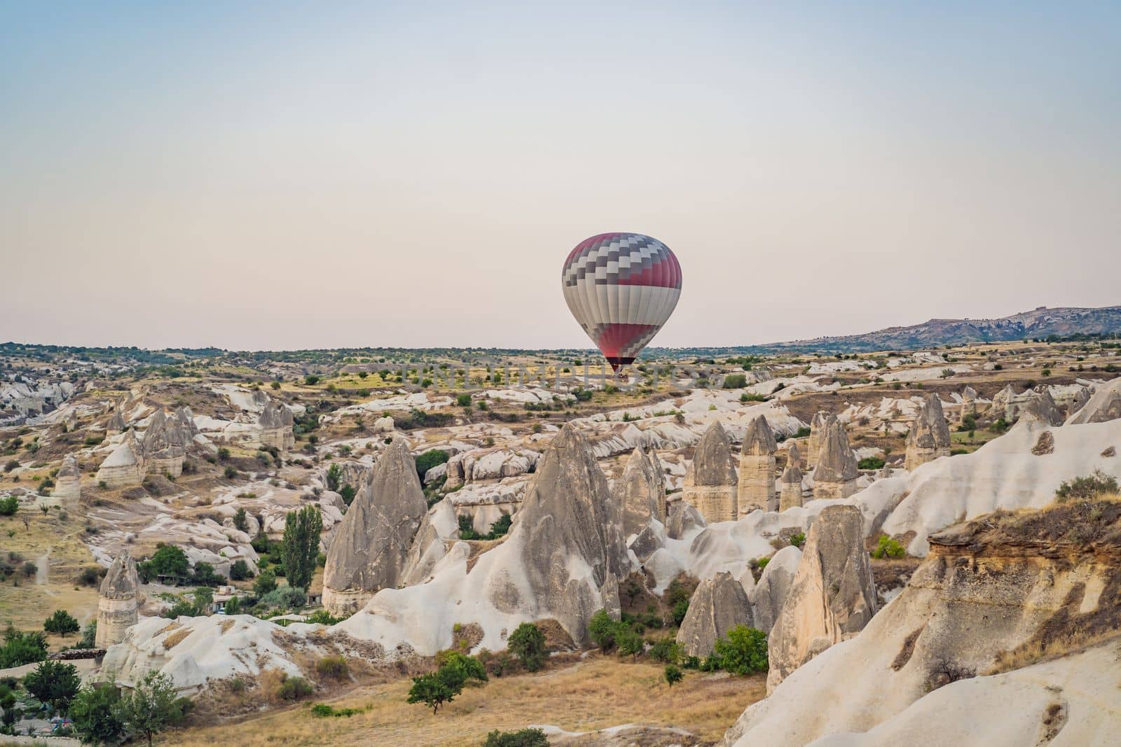 Colorful hot air balloon flying over Cappadocia, Turkey by galitskaya