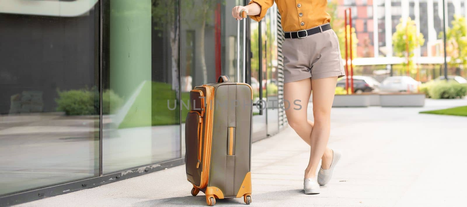 Traveler suitcase, woman carrying a suitcase in a travel location on holidays trip with lens flare technique, traveling on holidays concepts by Andelov13