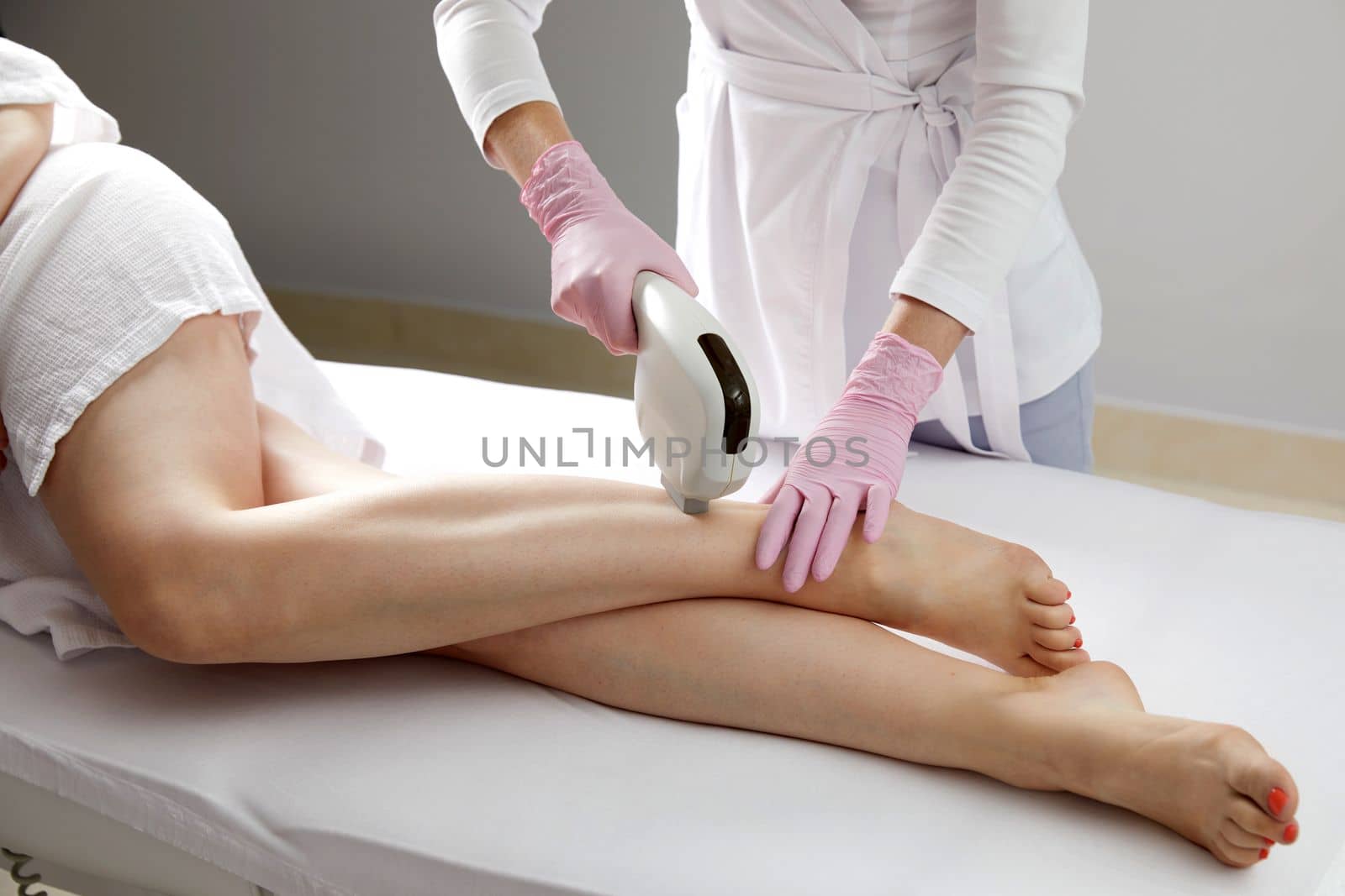 Laser hair removal on ladies legs in a beauty salon