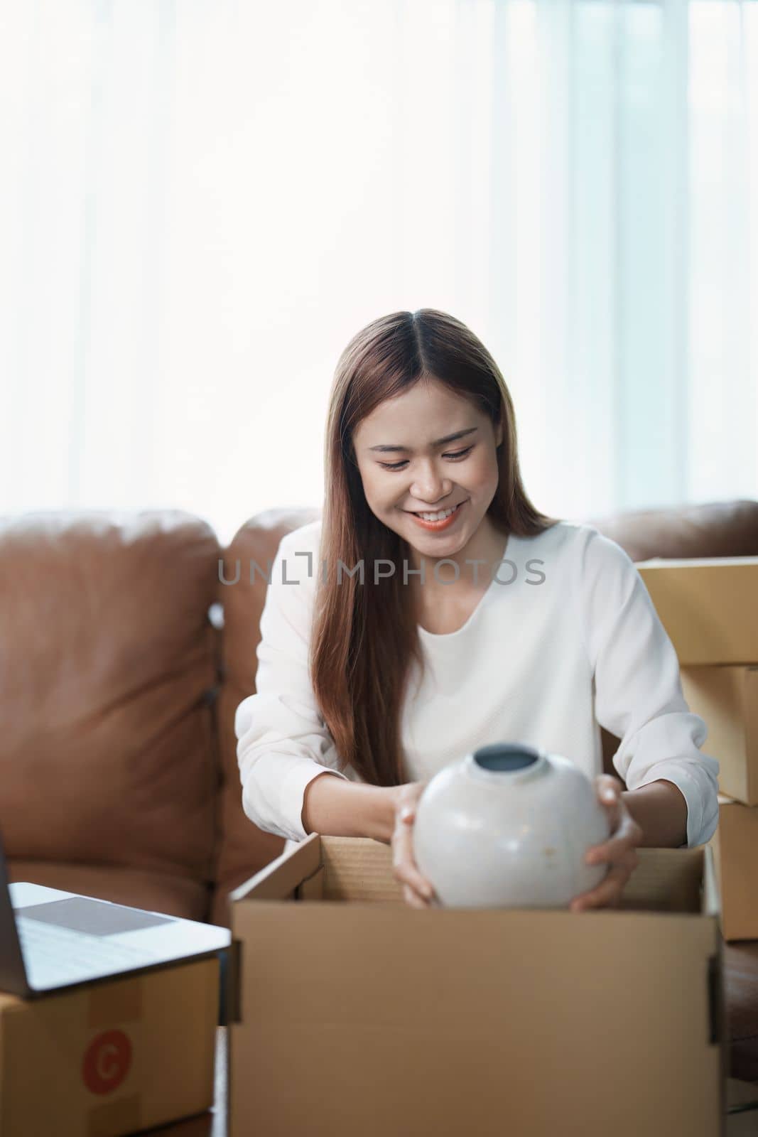 Starting small business entrepreneur of independent young Asian woman online seller using a computer showing products to a customer before making a purchase decision. SME delivery concept by Manastrong