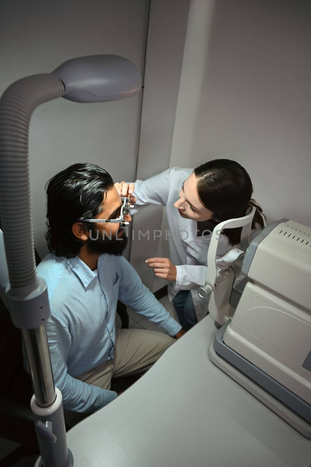 Ophthalmologist checking eye vision of patient for appropriate spectacles glasses. Eye health check and ophthalmology concept by prathanchorruangsak