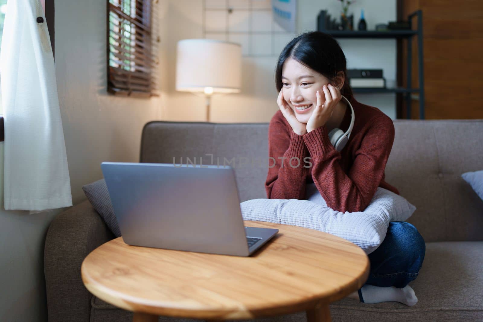 Portrait of a beautiful Asian teenage girl using a computer by Manastrong