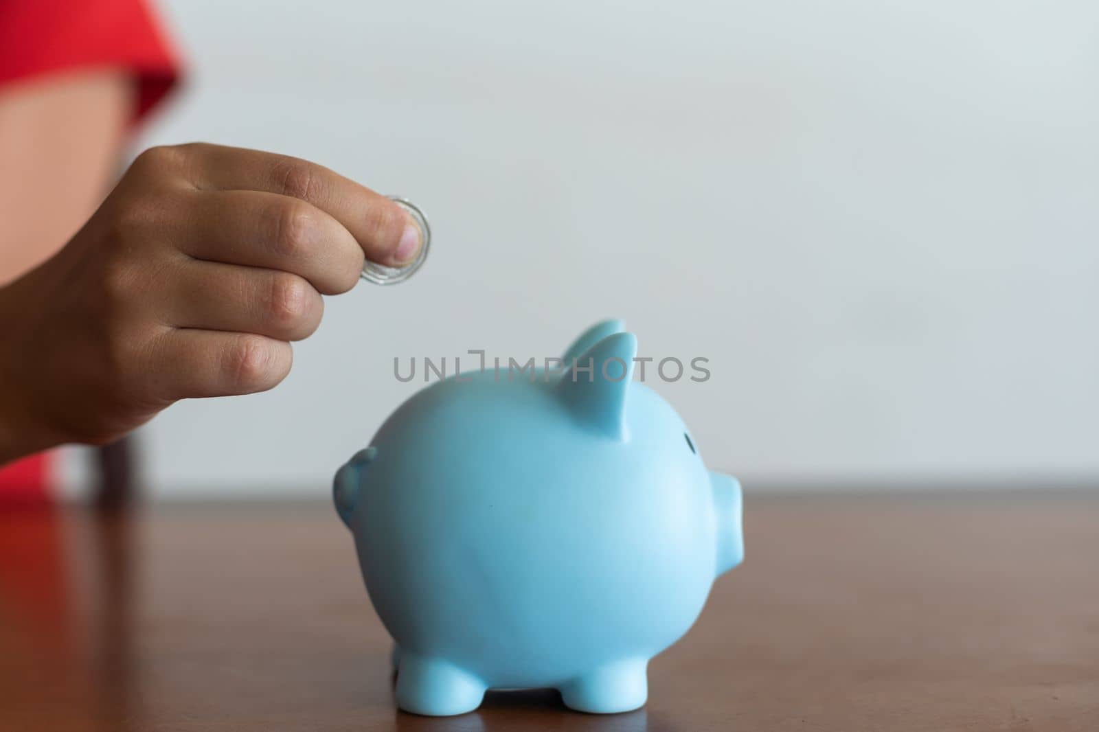 Pink piggy bank in the children's hands by Andelov13