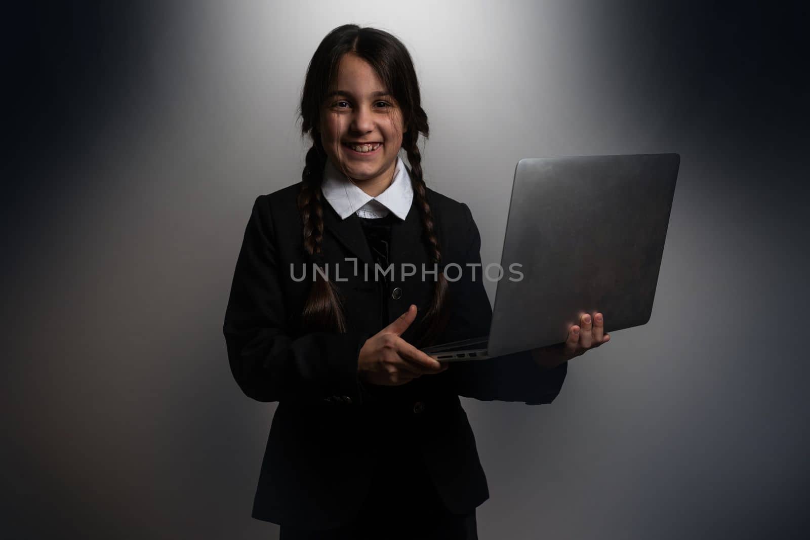 a girl in a black dress, Wednesday girl with a laptop.