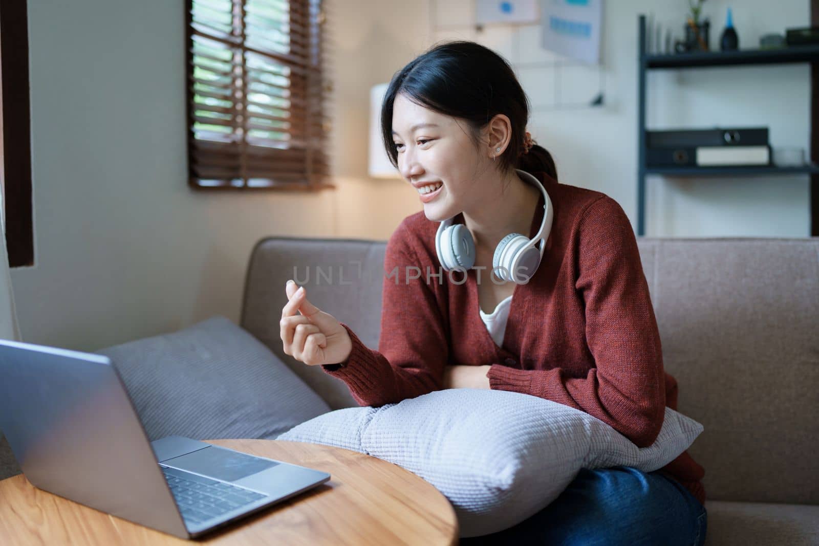 Portrait of a beautiful Asian teenage girl using a computer by Manastrong