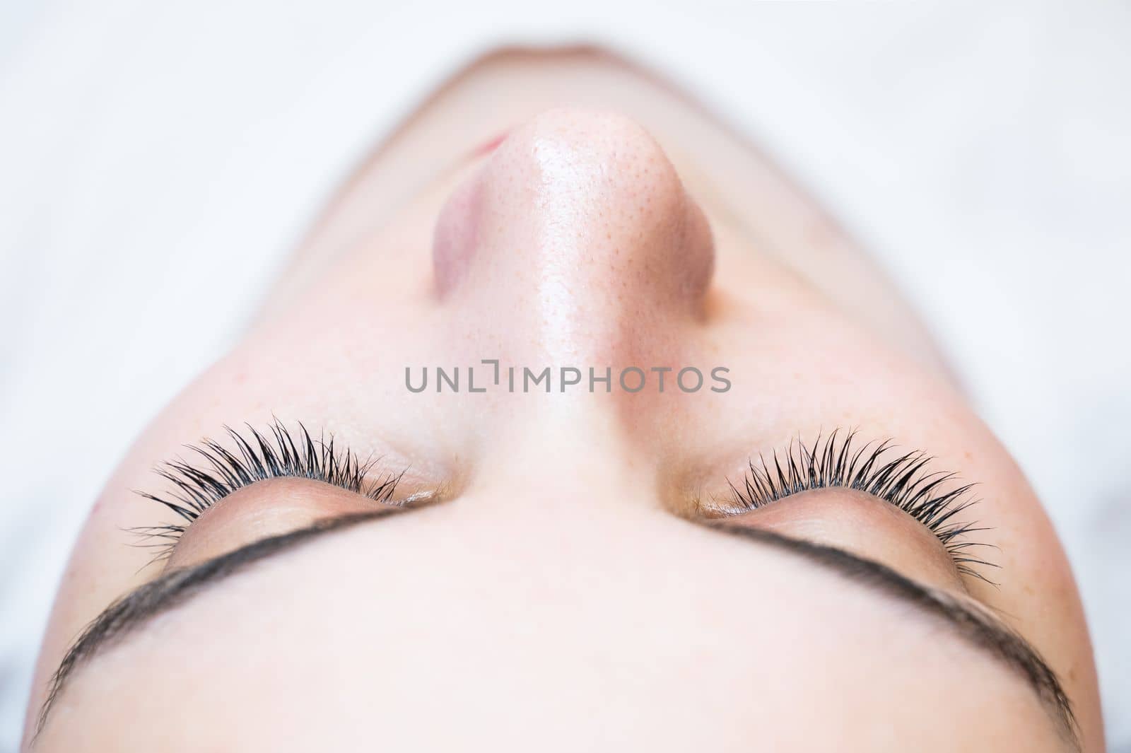 Close-up of a caucasian woman after eyelash lamination procedure