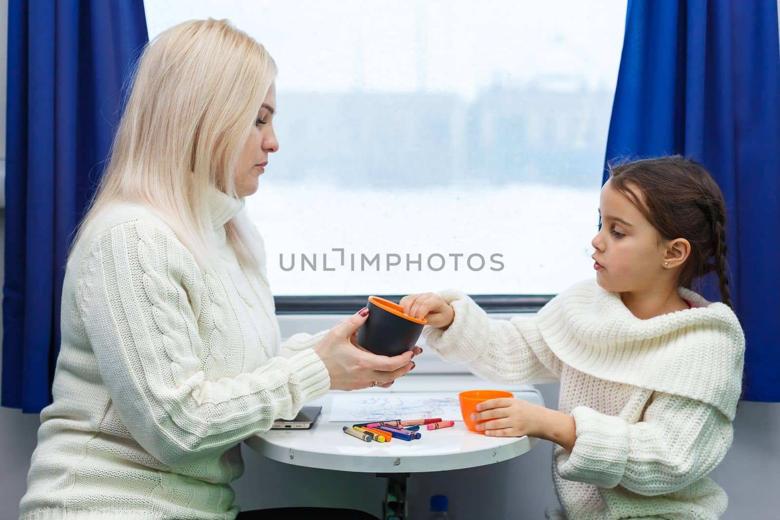 daughter and mother in the train go to the winter resort