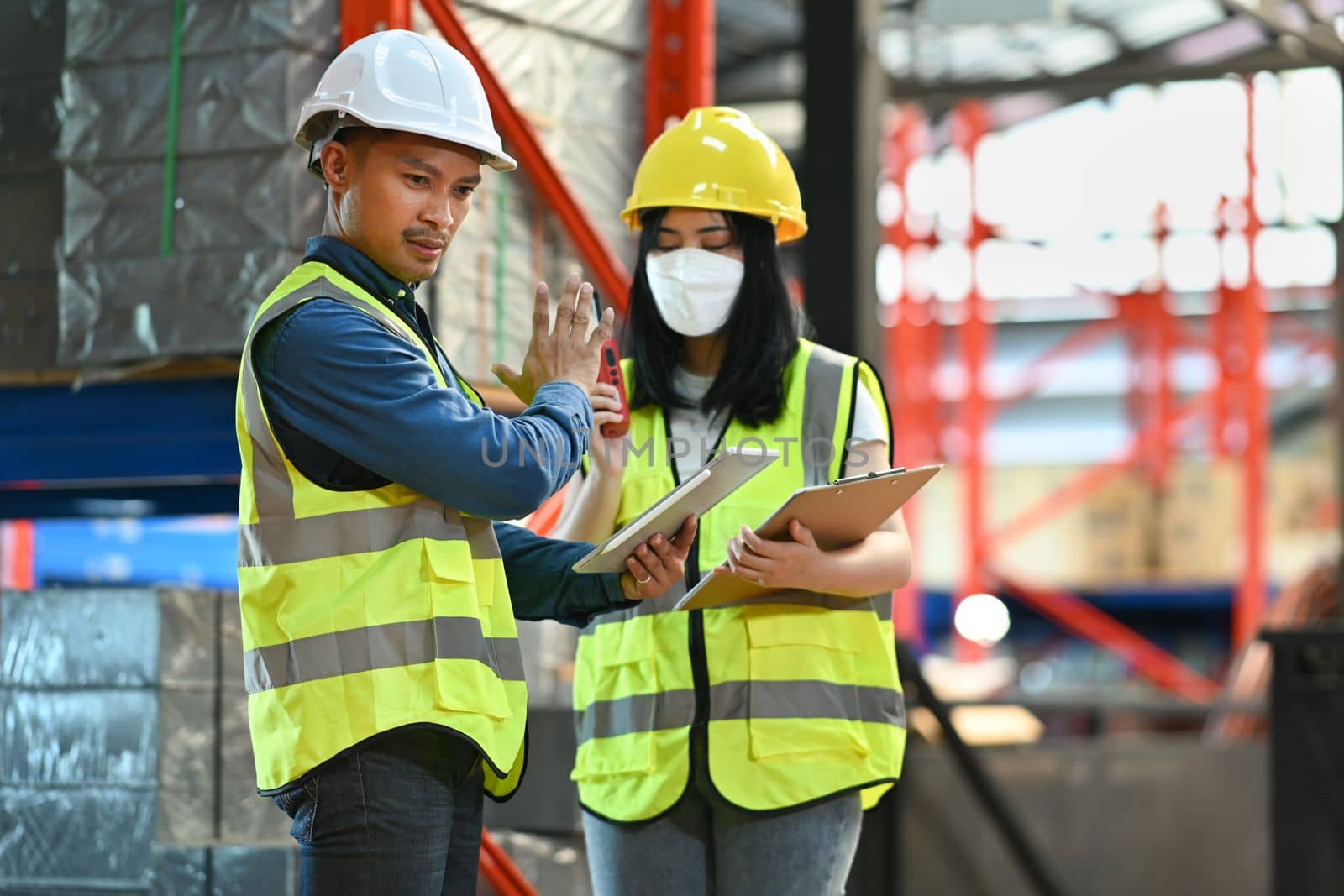 Storehouse workers are checking stock and inventory in retail warehouse. Business factory industry concept.