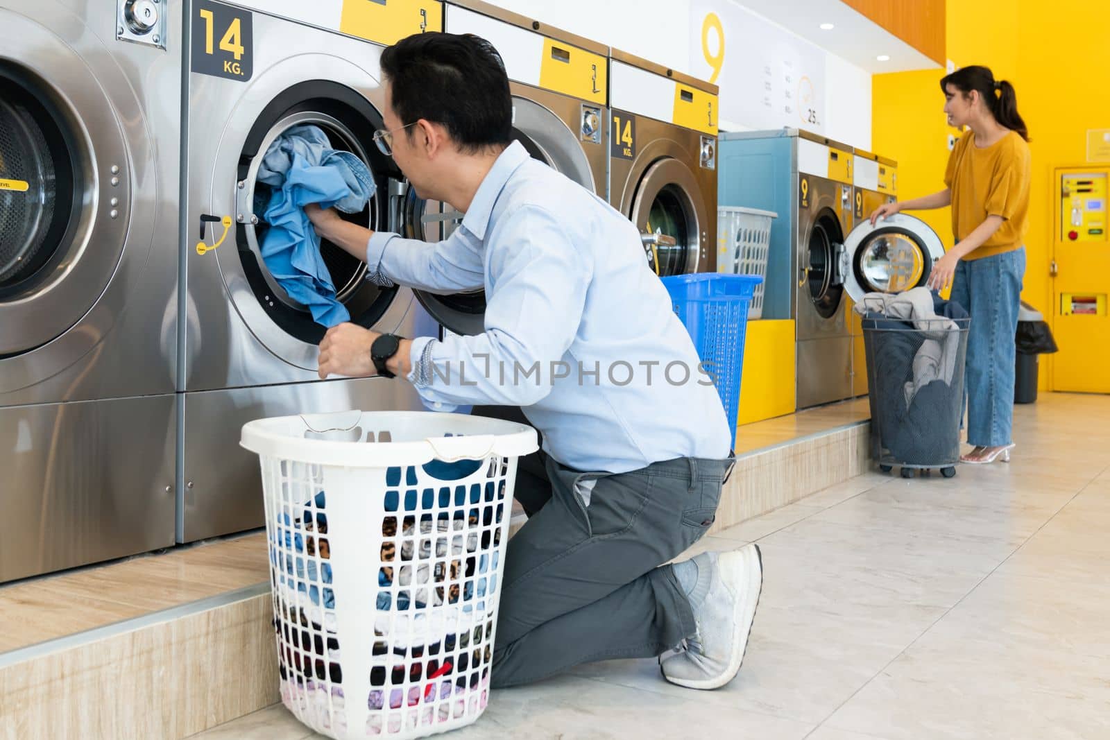 Asian people using qualified laundry machine in the public room. by biancoblue