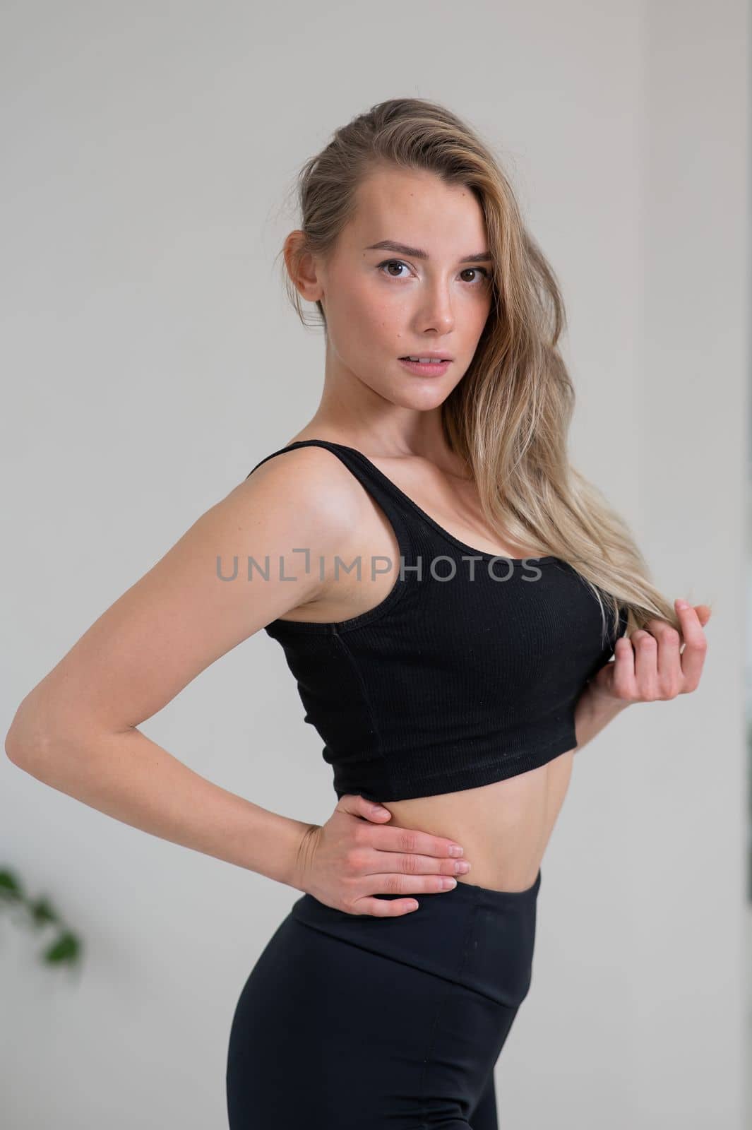 Portrait of a beautiful caucasian woman in black sportswear. by mrwed54