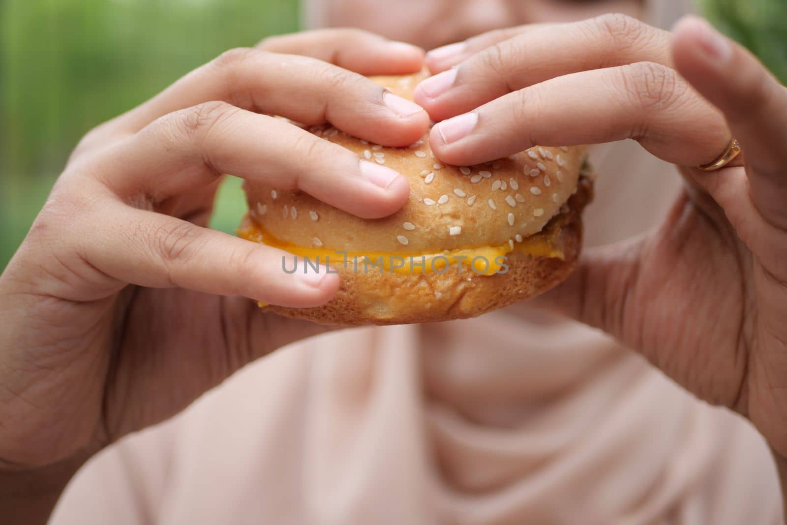 women hand holding beef burger top view ,