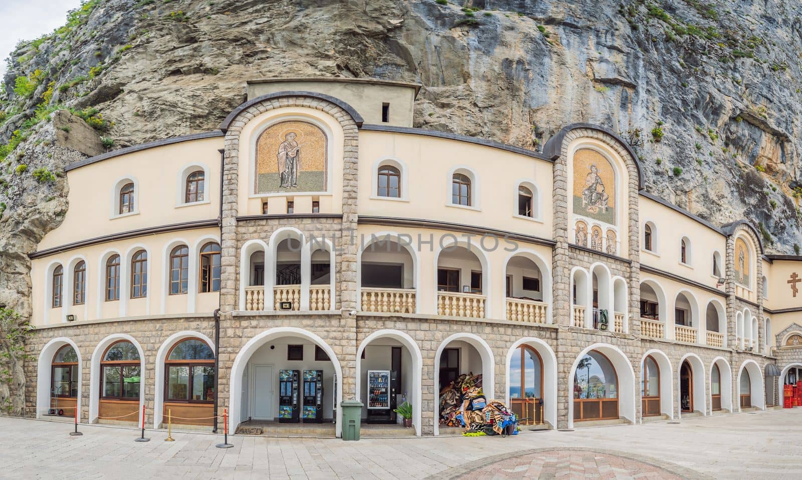 Monastery of Ostrog, Serbian Orthodox Church situated against a vertical background, high up in the large rock of Ostroska Greda, Montenegro. Dedicated to Saint Basil of Ostrog by galitskaya